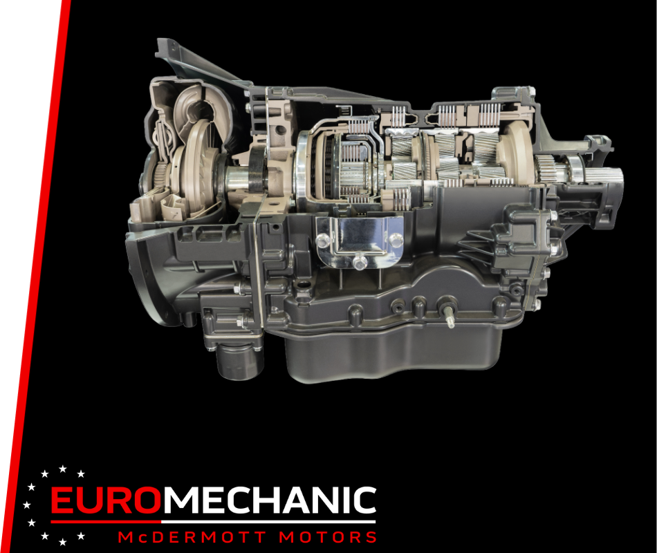 Cross-section of a car transmission system with exposed gears and components against a black background, illustrating the precision of transmission repair. The bottom left corner features the text Euromechanic McDermott Motors in white and red lettering. EuroMechanic | McDermott Motors Auto | Top Reviewed Auto Repair Shop in Toronto | Visit mcdermottmotors.com