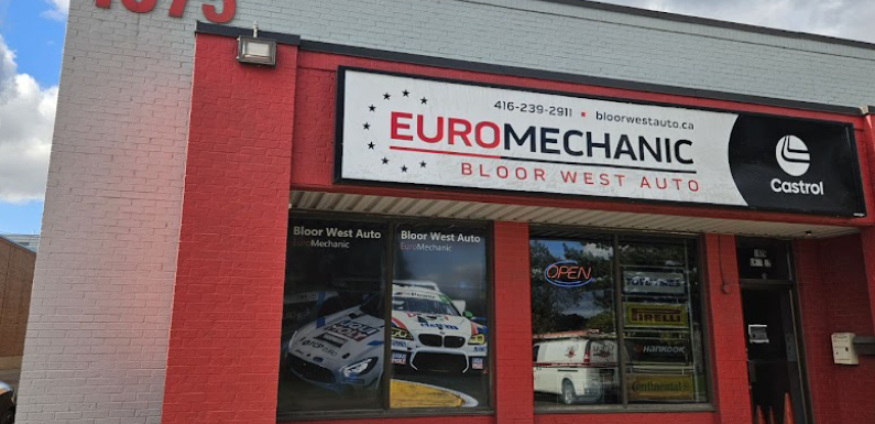 A red and white building displaying signs for Euromechanic Bloor West Auto and Castrol. The address number 1675 is visible. A window shows car-related images and an Open sign. EuroMechanic | McDermott Motors Auto | Top Reviewed Auto Repair Shop in Toronto | Visit mcdermottmotors.com