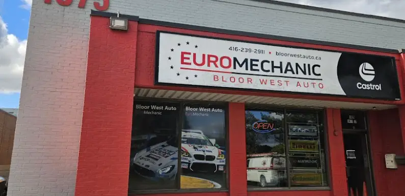 A red and white building displaying signs for Euromechanic Bloor West Auto and Castrol. The address number 1675 is visible. A window shows car-related images and an Open sign. EuroMechanic | McDermott Motors Auto | Top Reviewed Auto Repair Shop in Toronto | Visit mcdermottmotors.com