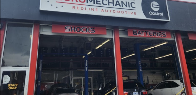 Exterior of an auto repair shop with a large sign reading EuroMechanic. The garage has several open bays with vehicles inside, and signs for services like Shocks and Batteries. A Staff Only sign is visible on a door. EuroMechanic | McDermott Motors Auto | Top Reviewed Auto Repair Shop in Toronto | Visit mcdermottmotors.com