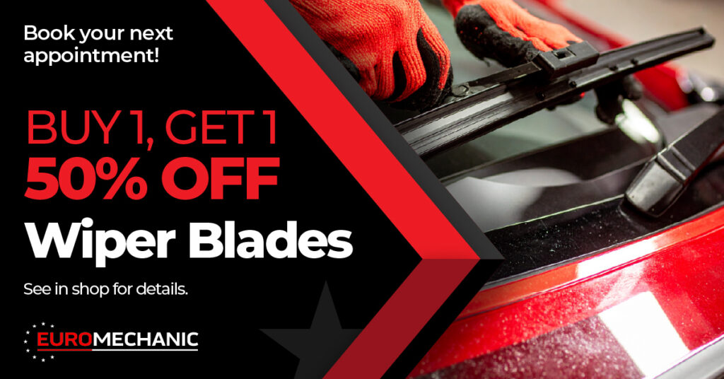 A close-up of hands replacing a windshield wiper blade on a red car. Text reads: Buy 1, Get 1 50% Off Wiper Blades. Book your next appointment! See in shop for details. EUROMECHANIC. EuroMechanic - McDermott Motors | Top Reviewed Auto Repair Shop in Toronto | Visit EuroMechanic - McDermott Motors